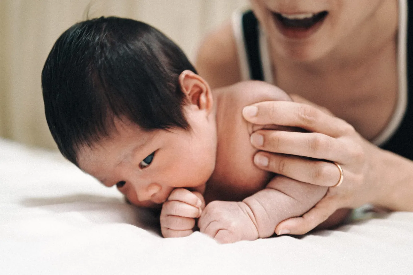 A parent and baby during tummy time at a Goji paediatric physiotherapy session.