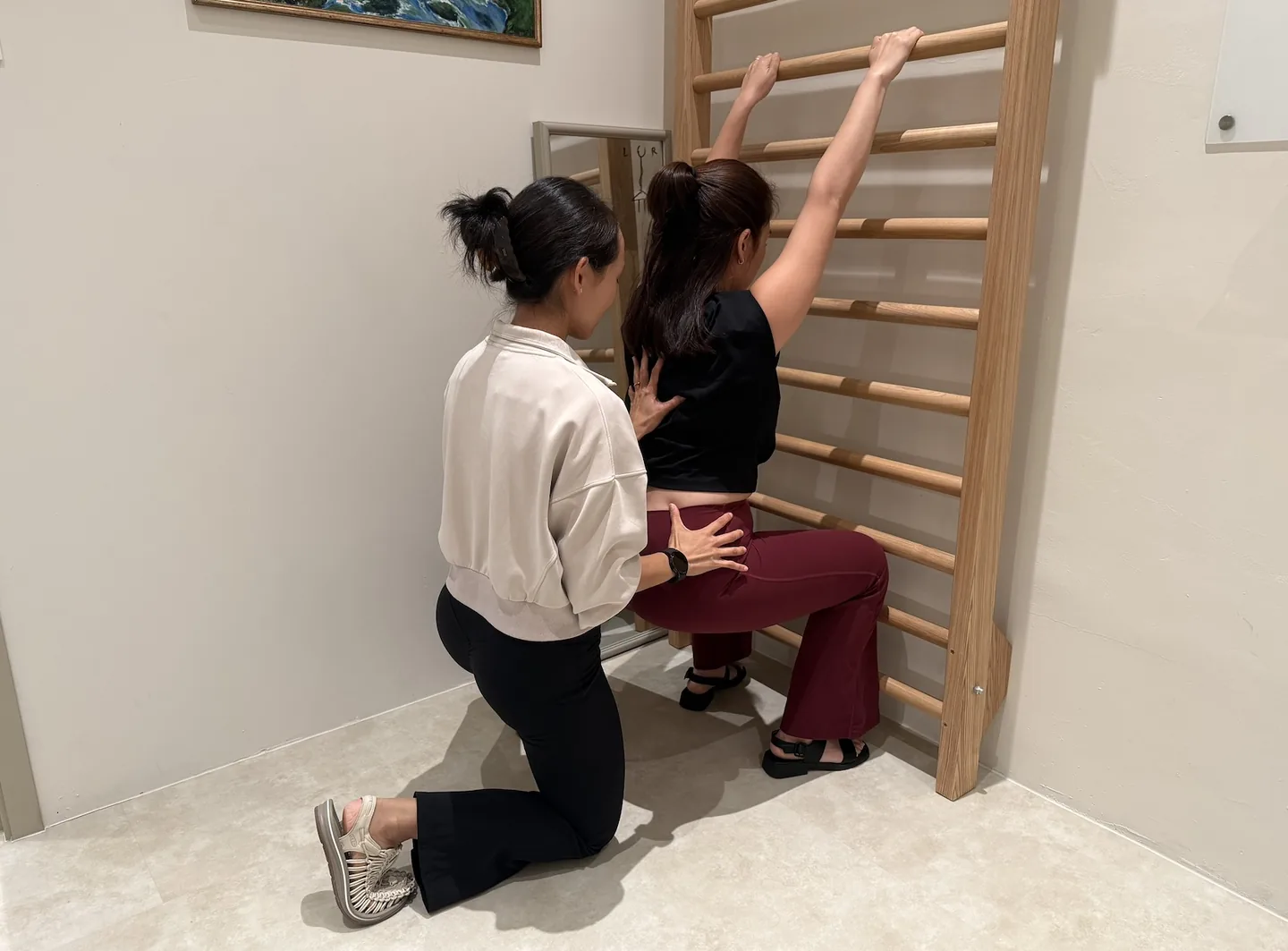 An adult practising Schroth Method scoliosis exercises with a Goji physiotherapist.