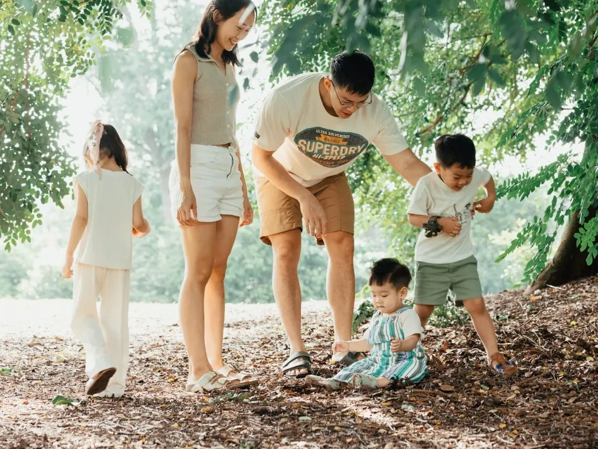 Cheryl outdoors in a park with her husband and their three children